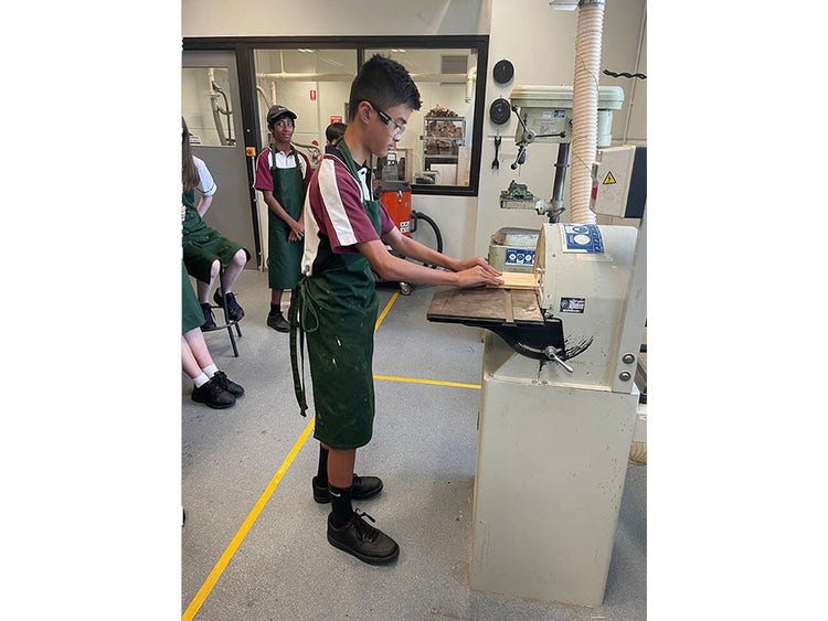 A student using a disc sander in class